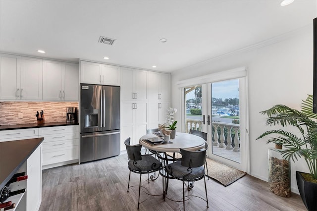 dining room featuring hardwood / wood-style flooring and french doors