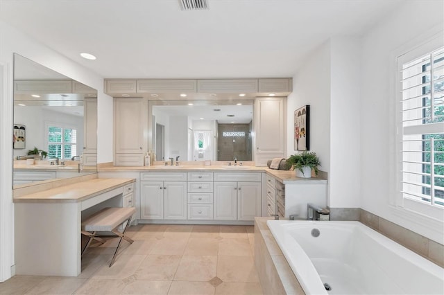 bathroom featuring tile patterned flooring, vanity, and separate shower and tub