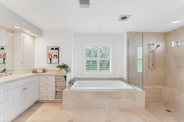 bathroom featuring tile patterned flooring, vanity, and separate shower and tub