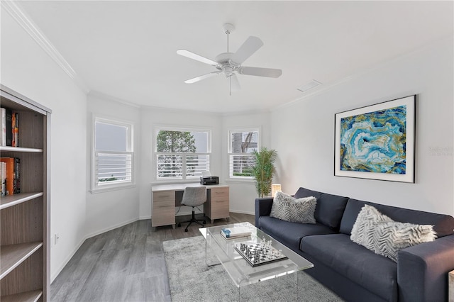 living room with ceiling fan, light wood-type flooring, and crown molding