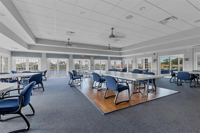 dining area featuring hardwood / wood-style floors, ceiling fan, and a paneled ceiling