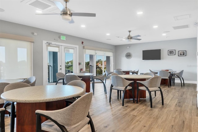 dining area with ceiling fan, french doors, and light hardwood / wood-style flooring