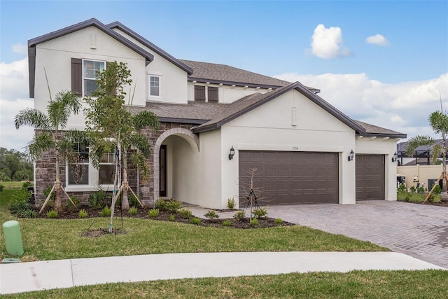 view of front of property with a garage and a front lawn