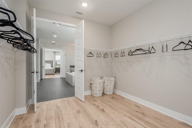 walk in closet featuring hardwood / wood-style floors