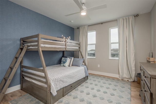 bedroom with ceiling fan and light wood-type flooring