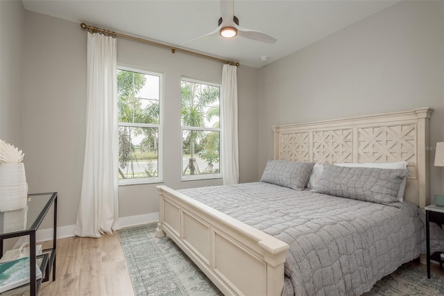 bedroom with ceiling fan and light hardwood / wood-style floors