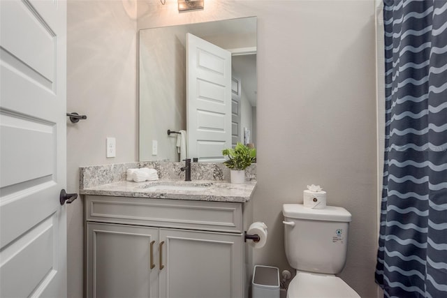 bathroom with toilet and vanity