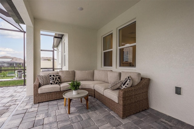 view of patio featuring outdoor lounge area and a lanai