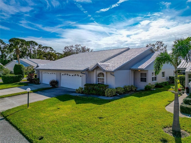 ranch-style house featuring a garage and a front yard