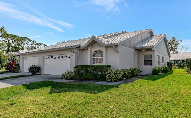 view of front of home featuring a garage and a front lawn