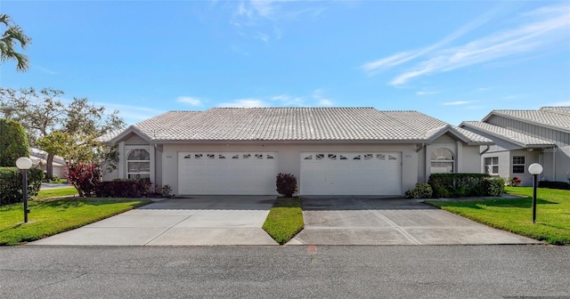 ranch-style home featuring a front yard and a garage