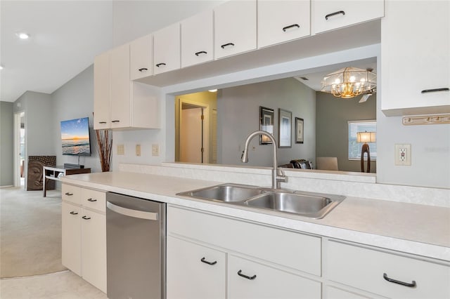 kitchen featuring pendant lighting, white cabinets, and stainless steel dishwasher