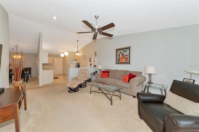 carpeted living room featuring ceiling fan with notable chandelier and vaulted ceiling