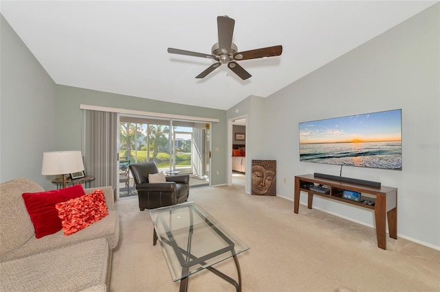 carpeted living room with ceiling fan and lofted ceiling