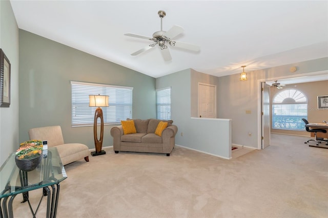 carpeted living room with ceiling fan and lofted ceiling