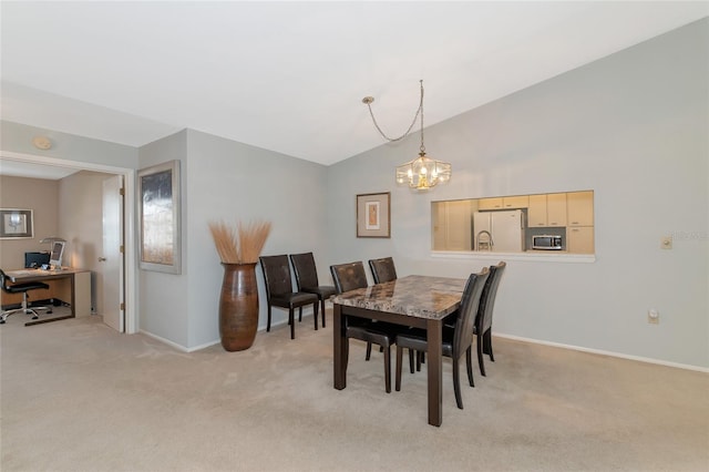 dining space with light colored carpet, vaulted ceiling, and a notable chandelier