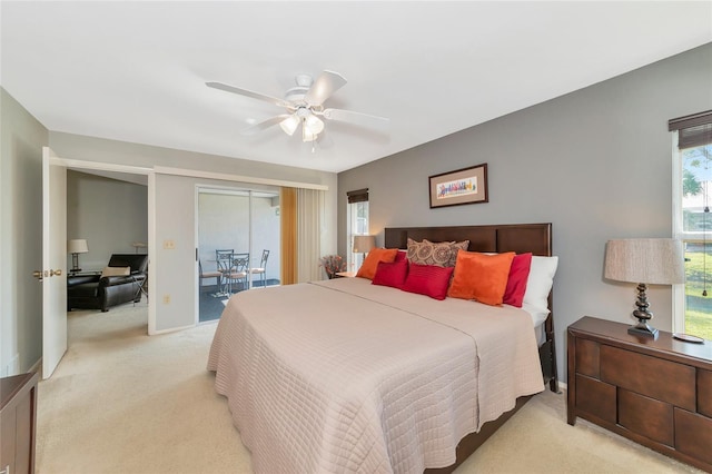 carpeted bedroom featuring access to exterior and ceiling fan