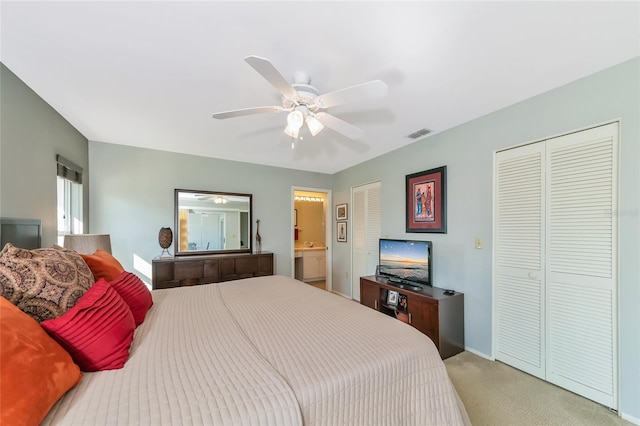 bedroom with ensuite bath, ceiling fan, and carpet floors