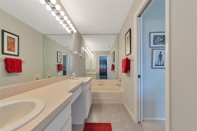 bathroom with tile patterned floors, vanity, and a bath