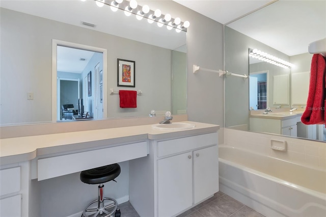 bathroom with a bathing tub, tile patterned flooring, and vanity