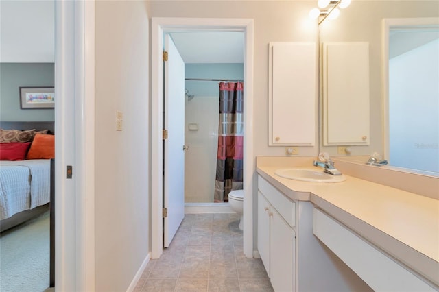 bathroom with tile patterned floors, vanity, toilet, and walk in shower