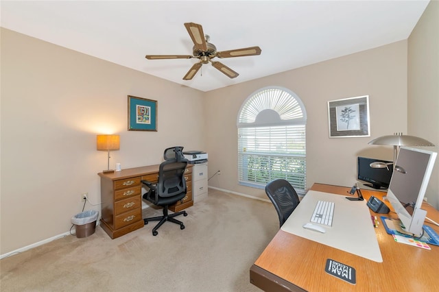 carpeted office featuring ceiling fan