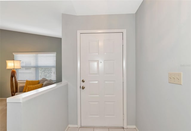 tiled entrance foyer featuring lofted ceiling