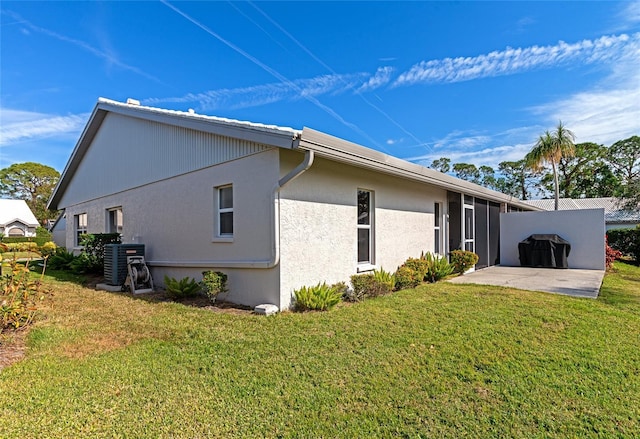 back of house with a yard, a patio, and central AC unit