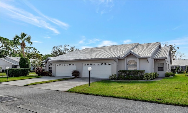 single story home with a front yard and a garage