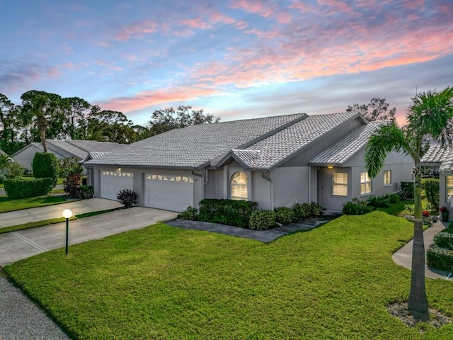 ranch-style house with a lawn and a garage