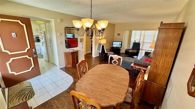 11485 Oakhurst Rd Unit 200-220, Largo, FL 33774 - tiled dining area featuring a chandelier and a textured ceiling