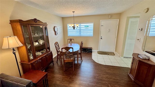 11485 Oakhurst Rd Unit 200-220, Largo, FL 33774 - dining area with a chandelier, a textured ceiling, dark wood-type flooring, and baseboards