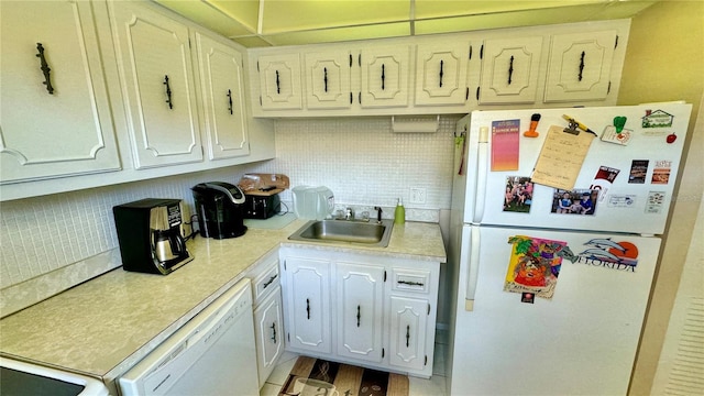 kitchen featuring light wood-type flooring, backsplash, white appliances, sink, and white cabinetry