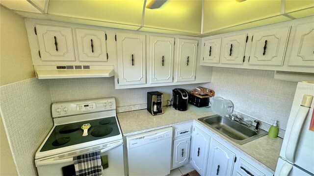 11485 Oakhurst Rd Unit 200-220, Largo, FL 33774 - kitchen featuring white appliances, under cabinet range hood, a sink, light countertops, and white cabinets
