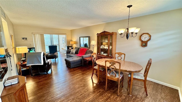 dining area featuring dark hardwood / wood-style flooring, a chandelier, and a textured ceiling