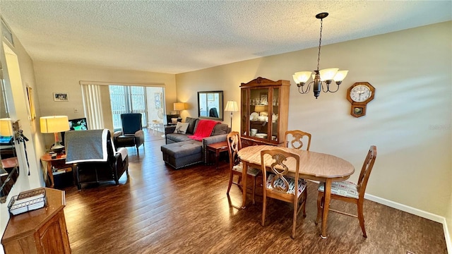 11485 Oakhurst Rd Unit 200-220, Largo, FL 33774 - dining area with dark wood-style floors, a textured ceiling, and a chandelier