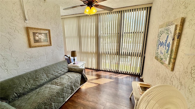 living room with dark hardwood / wood-style floors and ceiling fan