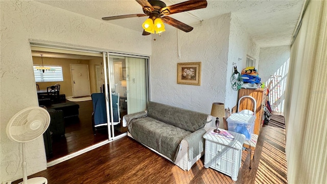 living room with ceiling fan and dark wood-type flooring