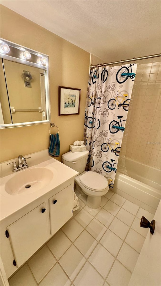 full bathroom featuring vanity, tile patterned floors, shower / bath combination with curtain, toilet, and a textured ceiling