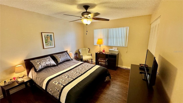 bedroom featuring a textured ceiling, ceiling fan, and dark wood-type flooring