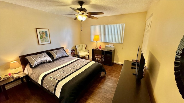 bedroom featuring ceiling fan, dark hardwood / wood-style flooring, and a textured ceiling