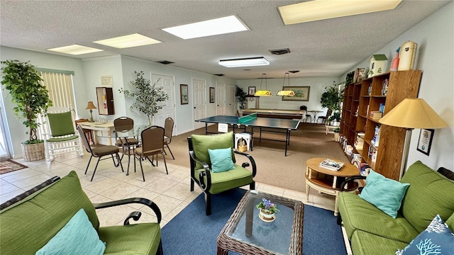 recreation room with light tile patterned flooring and a textured ceiling