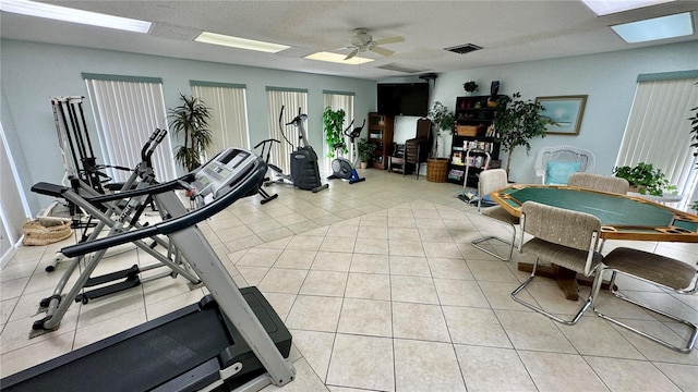 interior space with ceiling fan and light tile patterned flooring