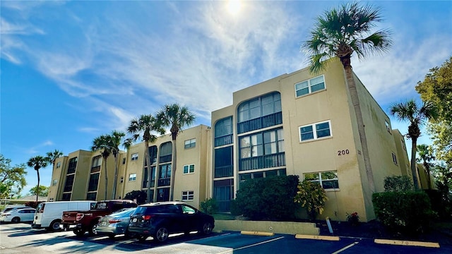 11485 Oakhurst Rd Unit 200-220, Largo, FL 33774 - view of apartment building / complex featuring uncovered parking