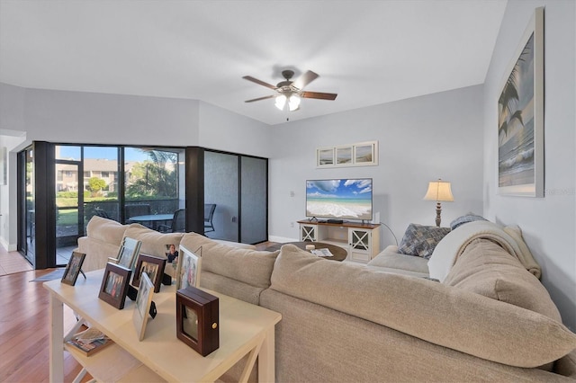 living room with ceiling fan and hardwood / wood-style floors