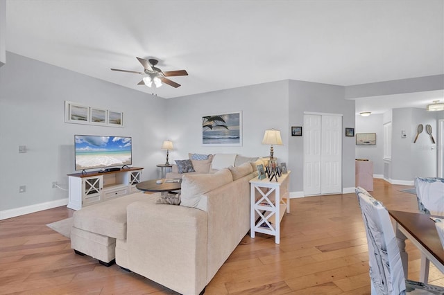 living room with hardwood / wood-style floors and ceiling fan