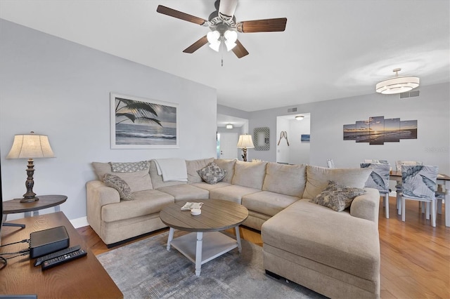 living room with ceiling fan and hardwood / wood-style floors