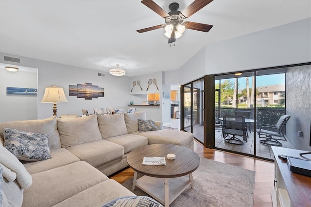 living room featuring wood-type flooring and ceiling fan