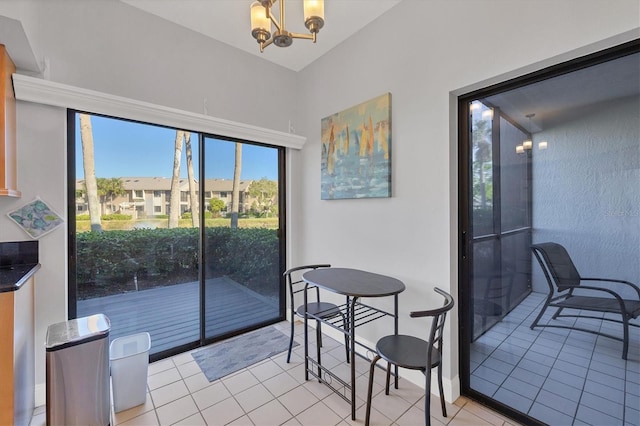 dining area featuring a notable chandelier and light tile patterned flooring