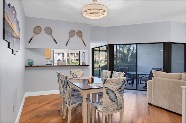 dining space with hardwood / wood-style flooring